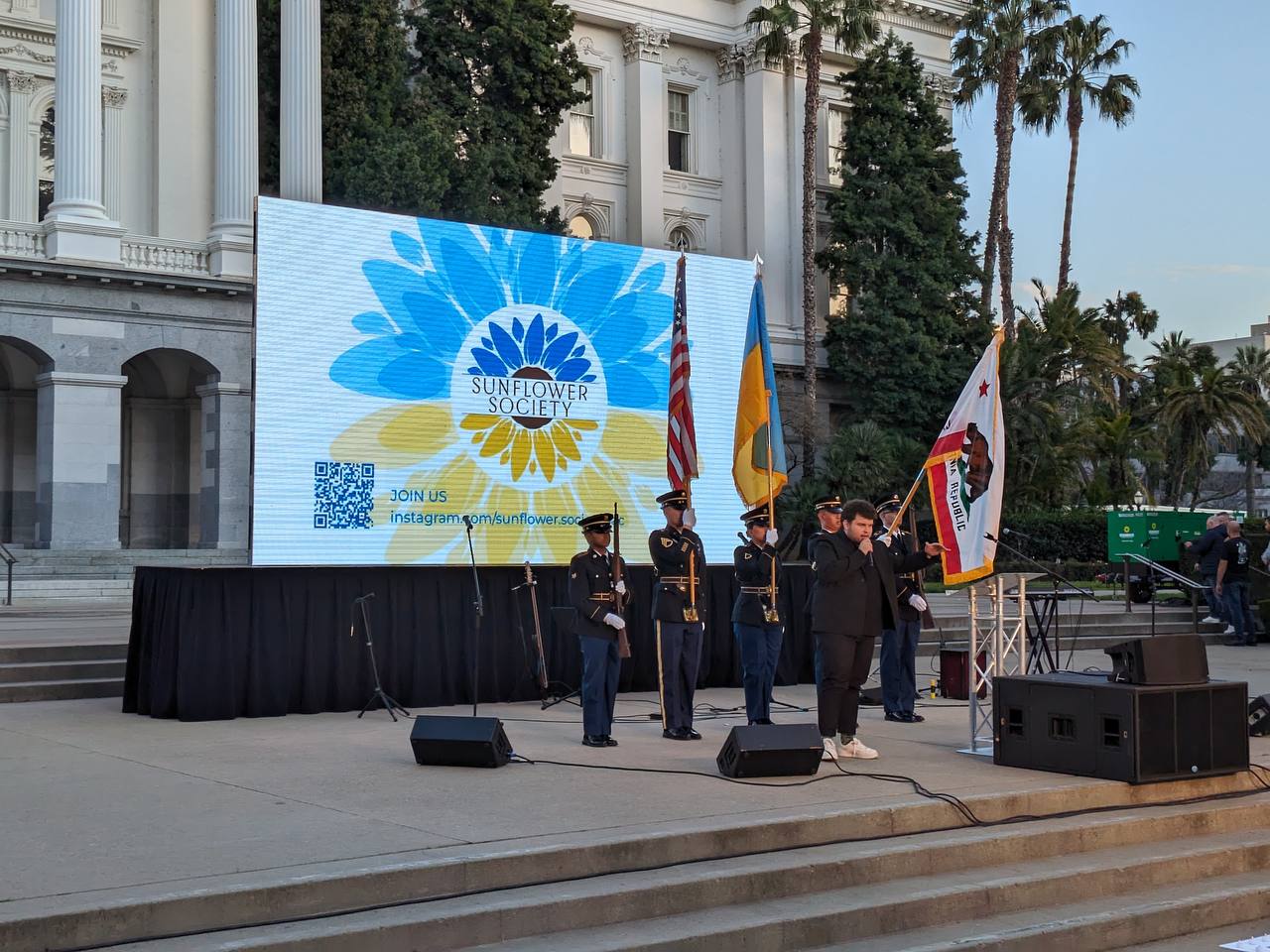 Speakers address a crowd at a Sacramento solidarity rally for Ukraine.
